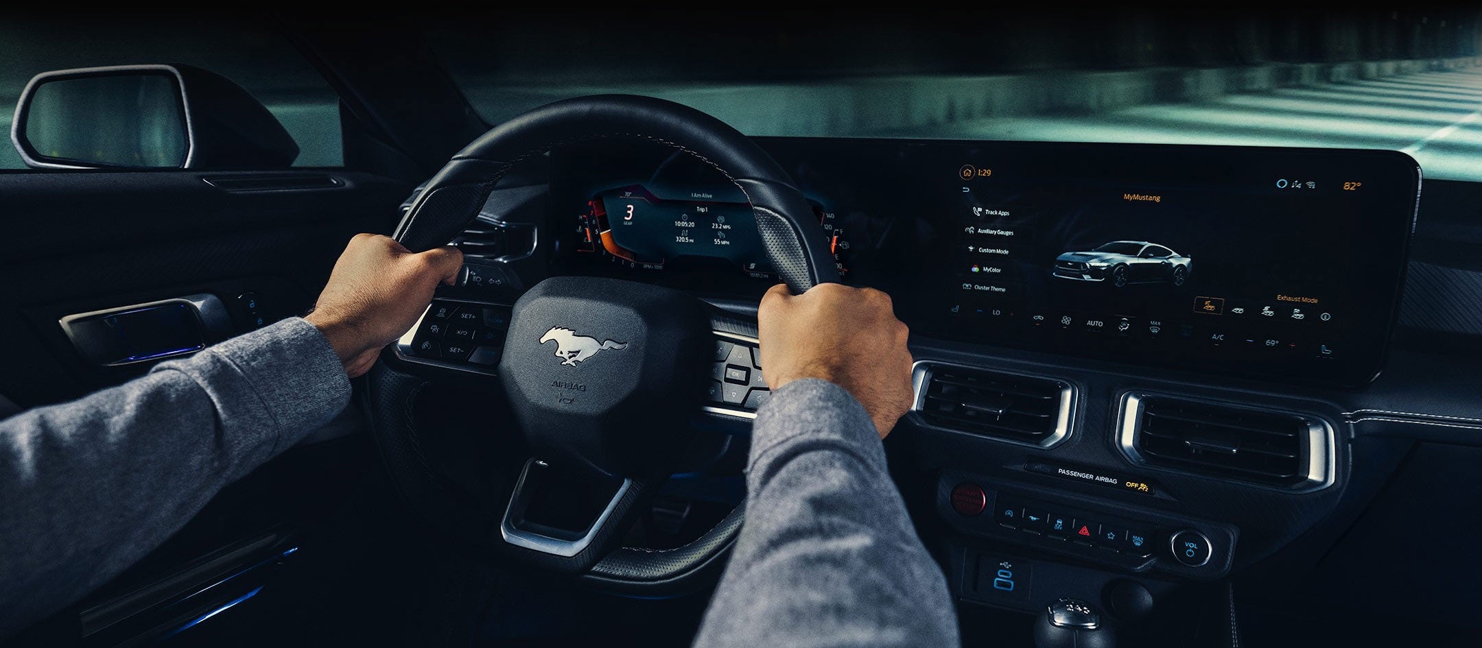 A 2024 Ford Mustang® model interior with a person driving | V & H Ford of Marshfield in Marshfield WI